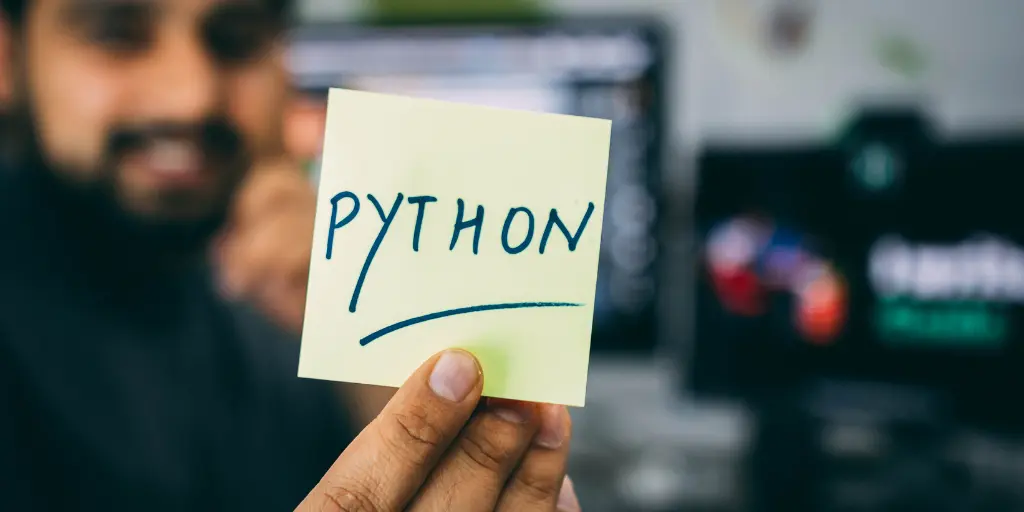 A developer showing a paper written with "Python"